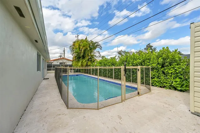 a view of a backyard with wooden fence