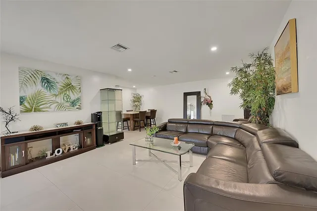 a living room with furniture and a potted plant