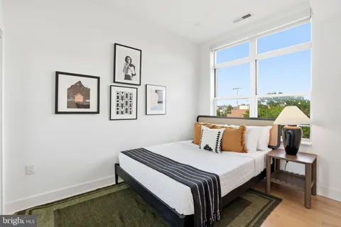 a bedroom with a bed and a table