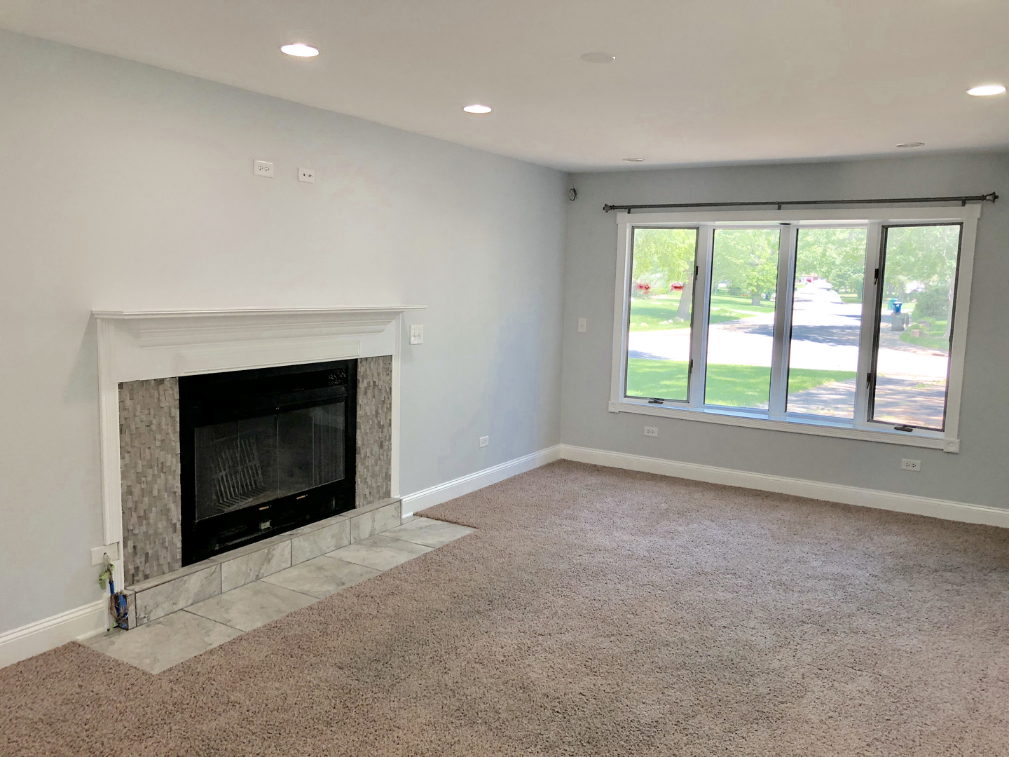 24 Pomeroy Road Montgomery, IL 60538 - Photo 13 of 29 an empty room with a fireplace and a window