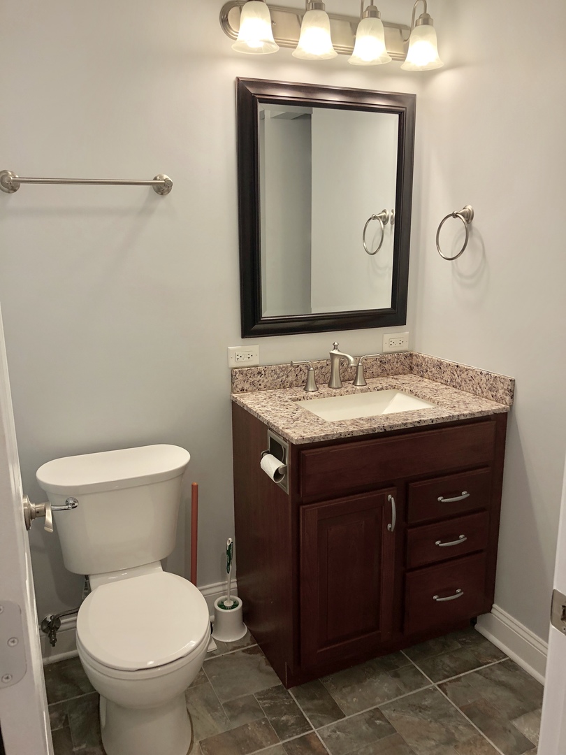 24 Pomeroy Road Montgomery, IL 60538 - Photo 16 of 29 a bathroom with a granite countertop toilet sink and mirror
