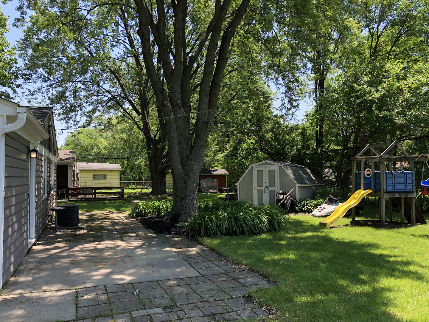 24 Pomeroy Road Montgomery, IL 60538 - Photo 26 of 29 a view of a backyard with a table and a slide