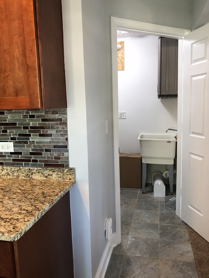 24 Pomeroy Road Montgomery, IL 60538 - Photo 9 of 29 a view of a kitchen from the hallway