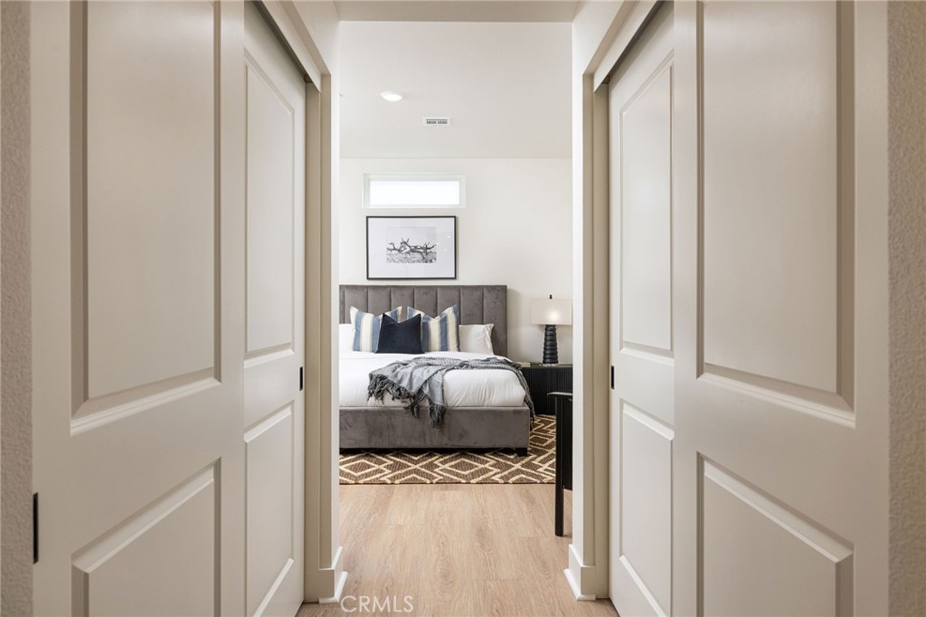 414 Main Street, Unit 410 Huntington Beach, CA 92648 - Photo 12 of 25 a bedroom with a bed and a window