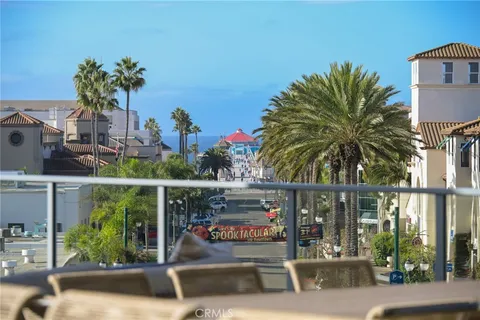 a view of a street with a building and palm trees