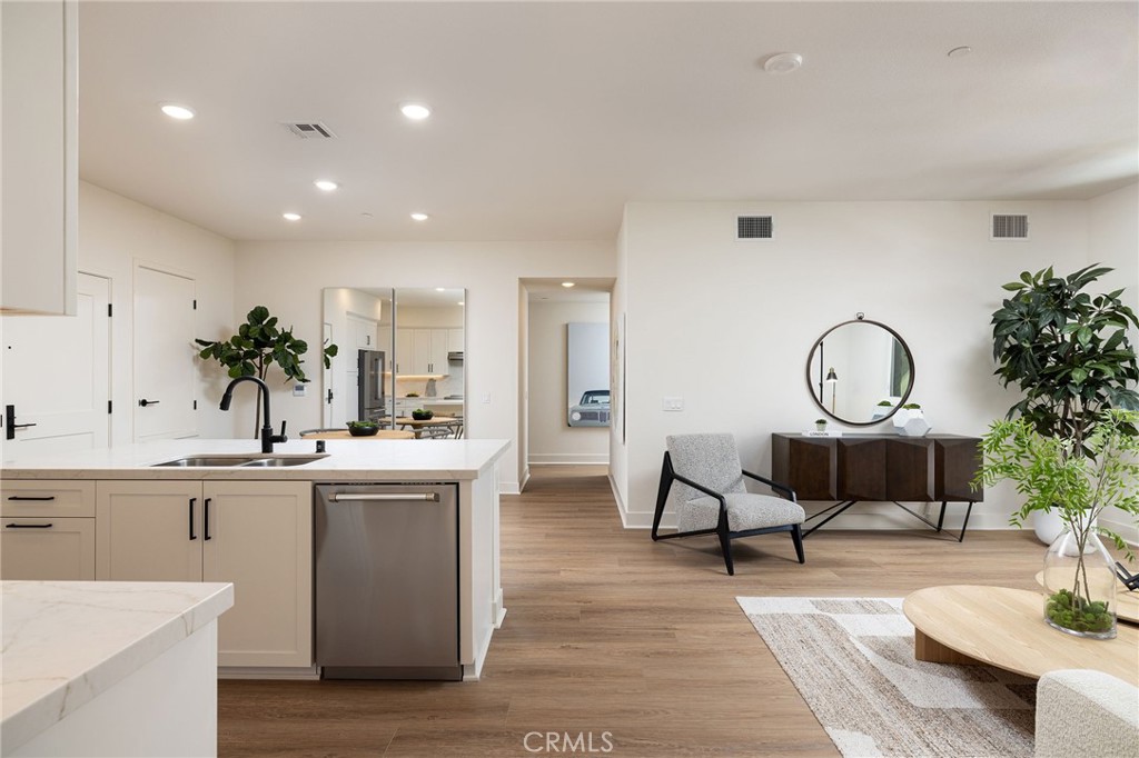 414 Main Street, Unit 410 Huntington Beach, CA 92648 - Photo 5 of 25 a view of living room kitchen with stainless steel appliances kitchen island granite countertop a sink a stove a dining table and chairs