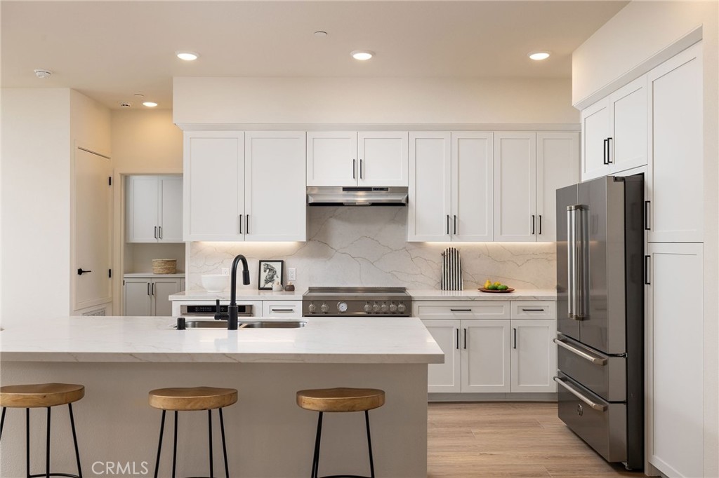 414 Main Street, Unit 410 Huntington Beach, CA 92648 - Photo 9 of 25 a kitchen with cabinets and stainless steel appliances