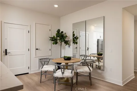 a dining room with furniture and a potted plant