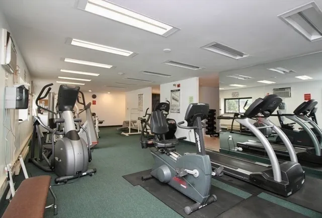a room with gym equipment and lots of gym equipment