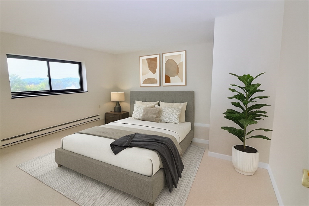 1321 Worcester Road, Unit 603 Framingham, MA 01701 - Photo 7 of 21 a bedroom with bed and a potted plant