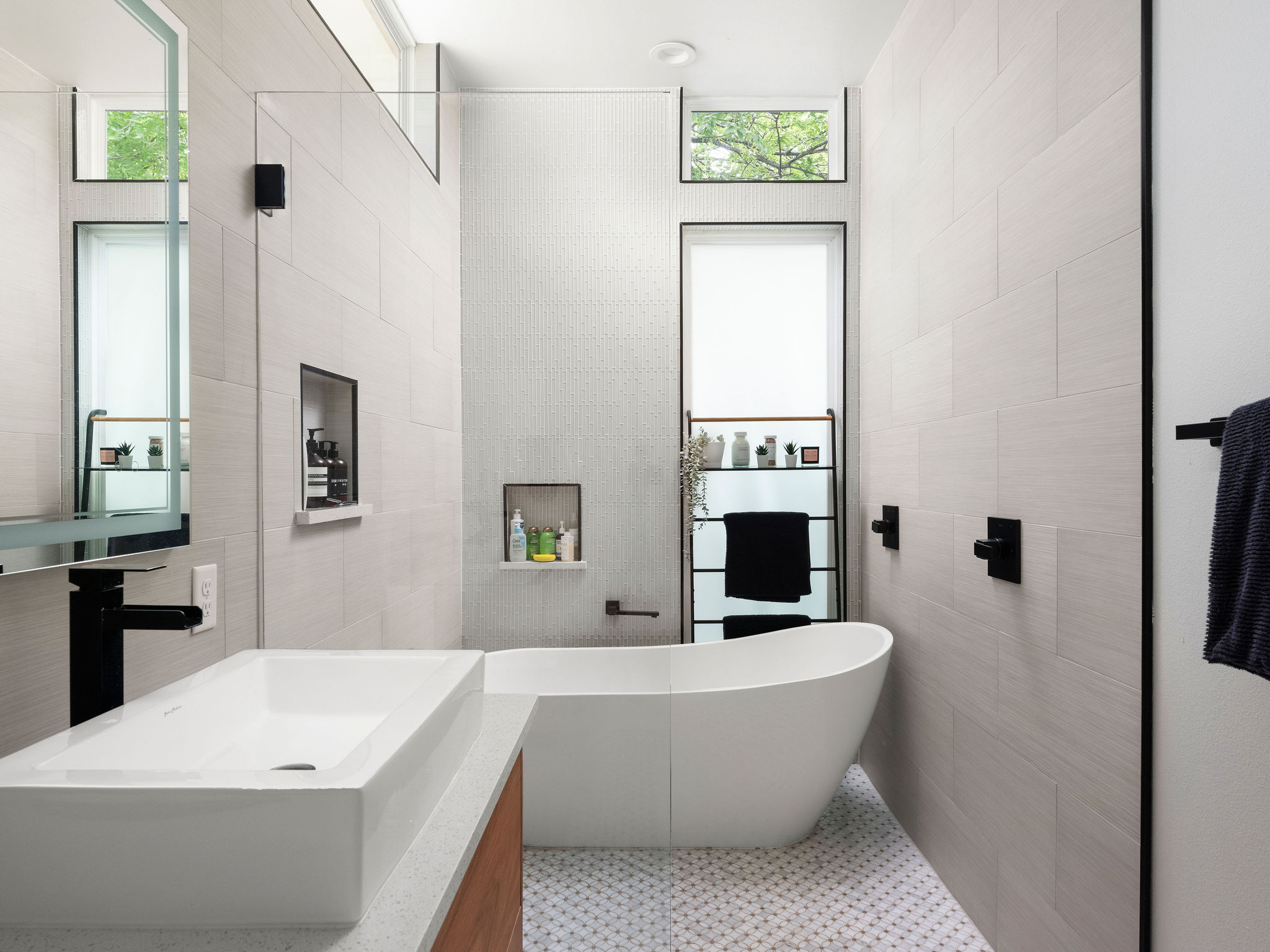 3710 Manorwood Road Austin, TX 78723 - Photo 20 of 40 A sleek modern bathroom featuring a freestanding tub and minimalist design.
