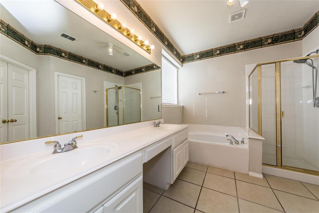 413 Sunrise Drive Allen, TX 75002 - Photo 16 of 23 a spacious bathroom with a granite countertop sink mirror and a bathtub