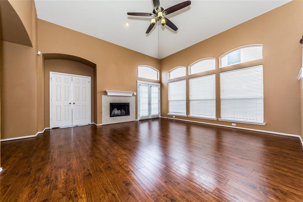 413 Sunrise Drive Allen, TX 75002 - Photo 5 of 23 an empty room with wooden floor fan and windows