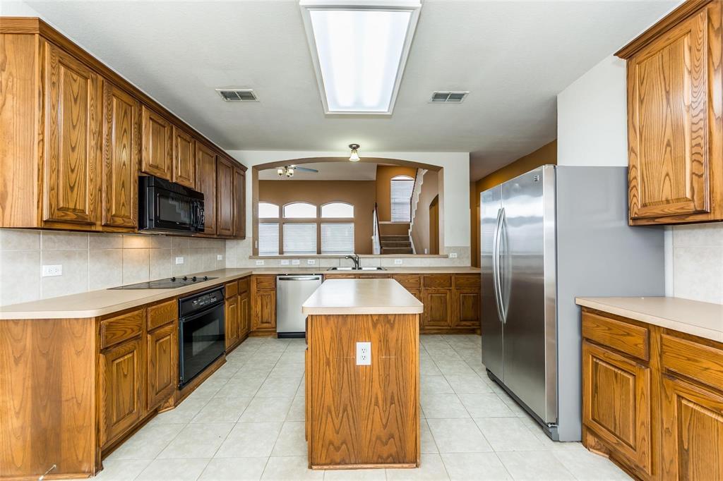 413 Sunrise Drive Allen, TX 75002 - Photo 8 of 23 a kitchen with stainless steel appliances granite countertop a refrigerator a stove top oven a sink and dishwasher