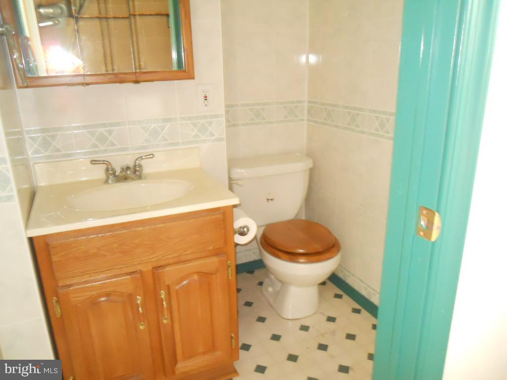 909 Brighton Avenue Reading, PA 19606 - Photo 17 of 35 a bathroom with a sink and a toilet