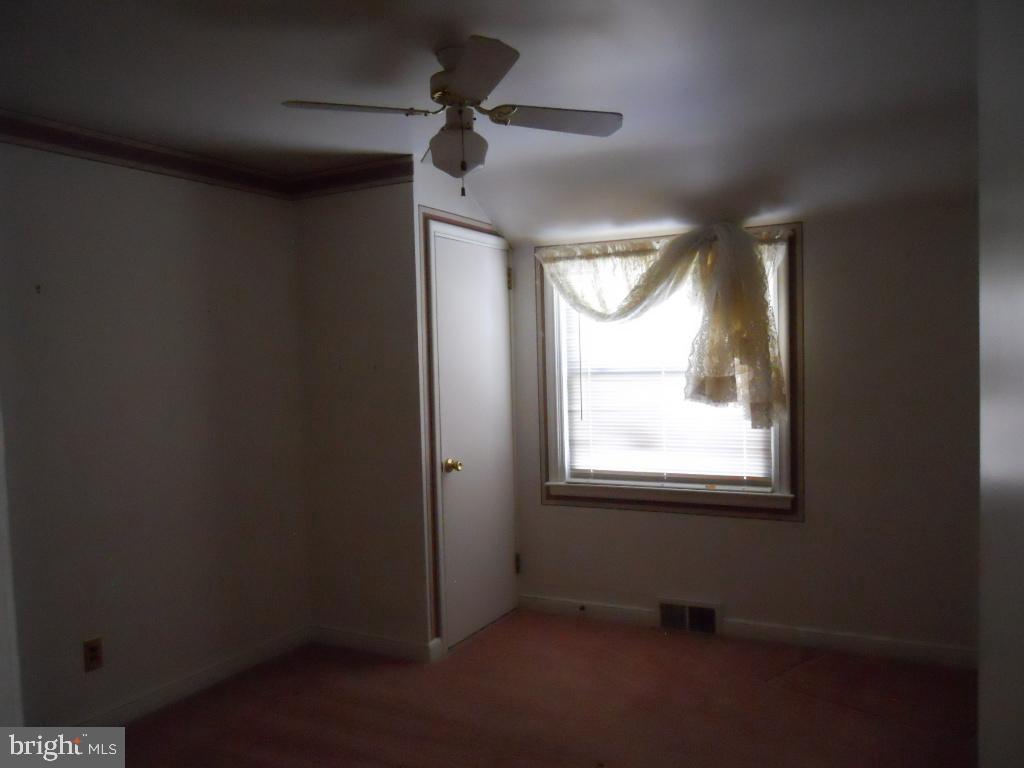 909 Brighton Avenue Reading, PA 19606 - Photo 24 of 35 an empty room with a window and a ceiling fan