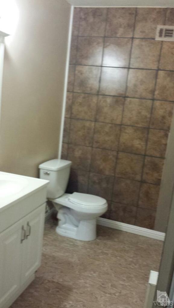 1684 Fitzgerald Road Simi Valley, CA 93065 - Photo 5 of 9 a white toilet sitting next to a bathroom sink