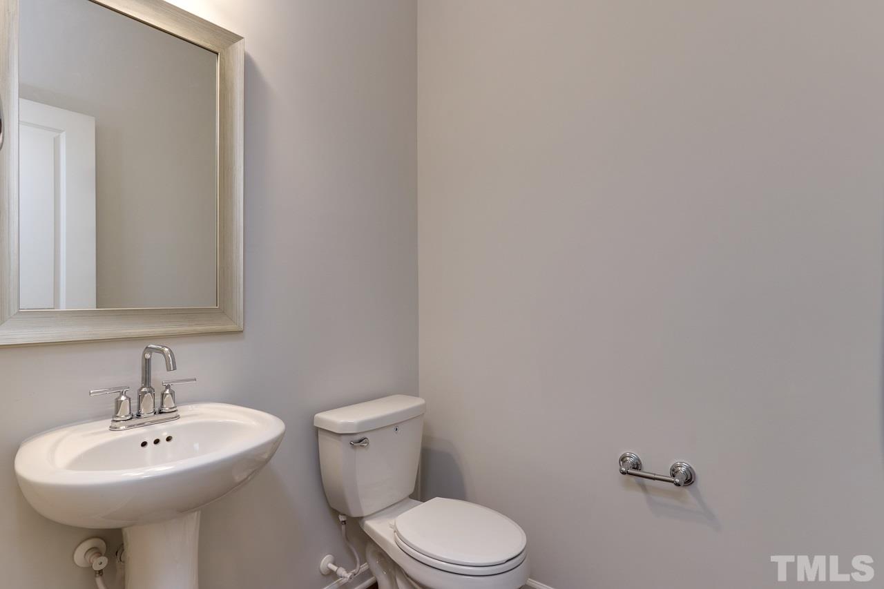 6055 Beale Loop, Unit 25 ABBEY Raleigh, NC 27616 - Photo 12 of 27 a bathroom with a sink a toilet and mirror