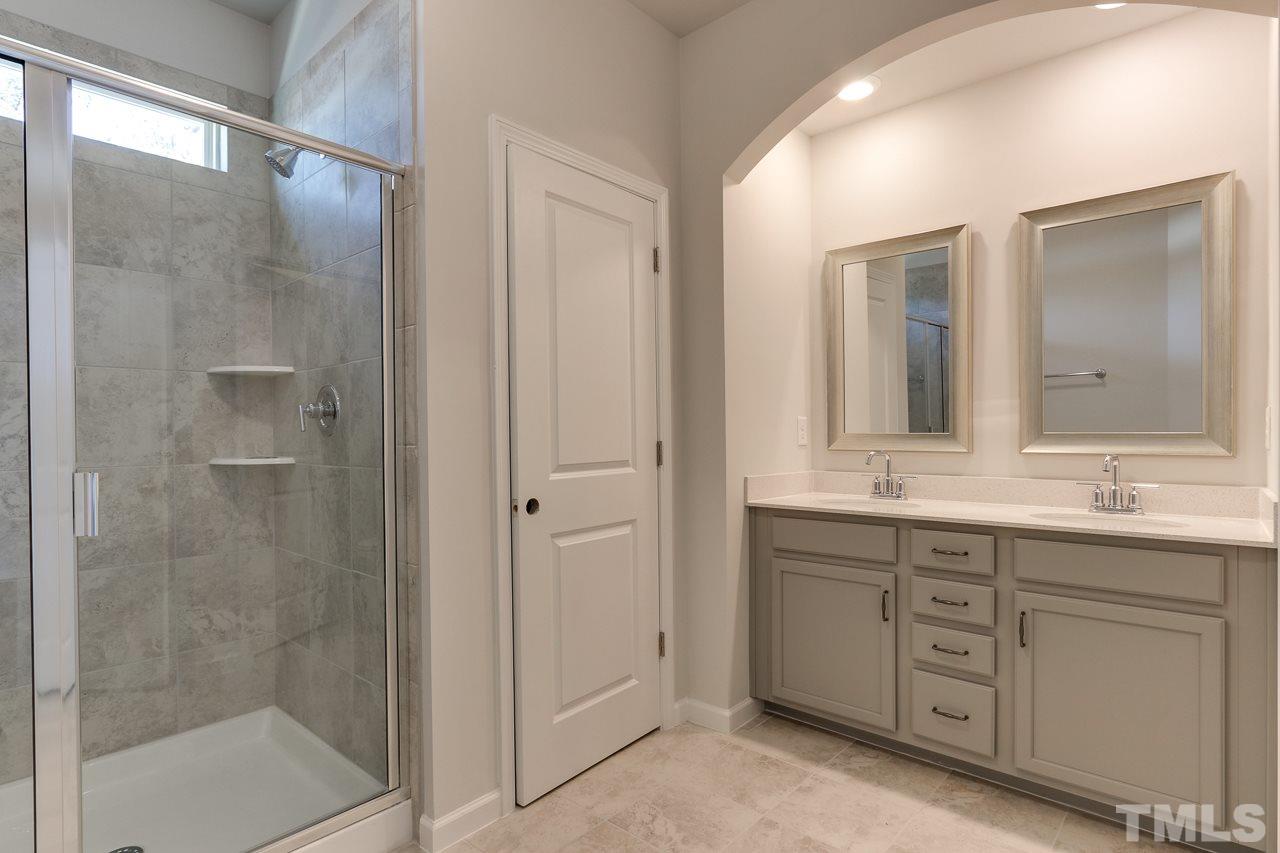 6055 Beale Loop, Unit 25 ABBEY Raleigh, NC 27616 - Photo 15 of 27 a bathroom with a granite countertop sink mirror and double
