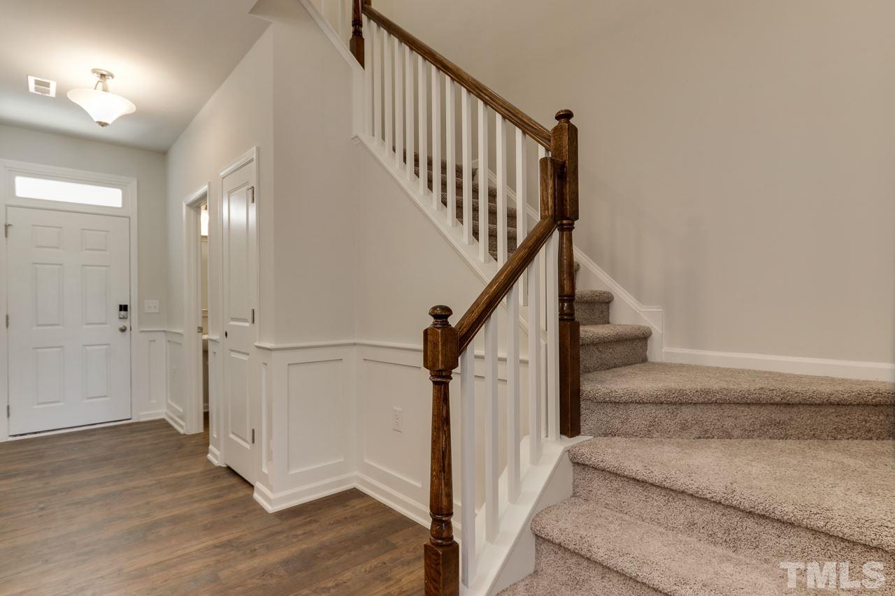 6055 Beale Loop, Unit 25 ABBEY Raleigh, NC 27616 - Photo 4 of 27 a view of staircase with white walls and railing