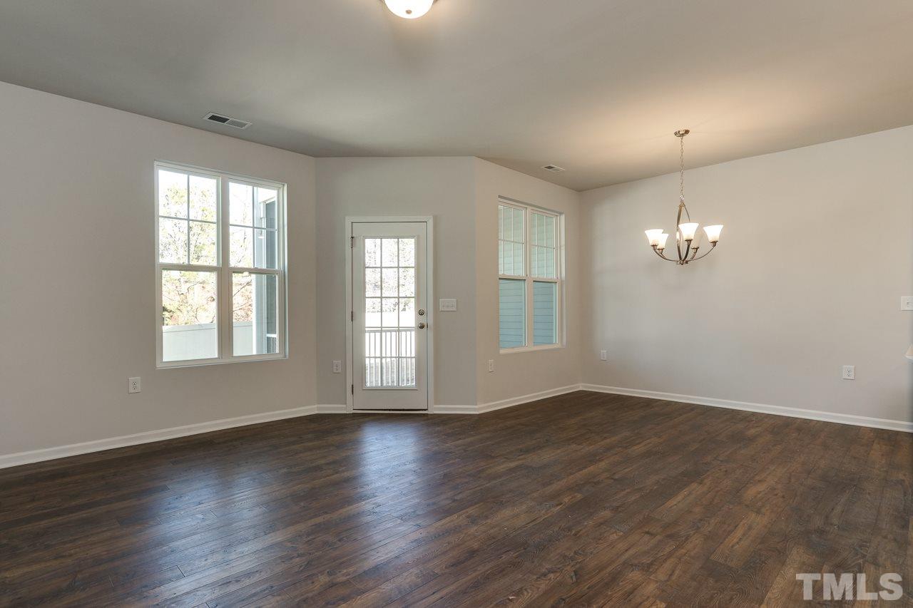 6055 Beale Loop, Unit 25 ABBEY Raleigh, NC 27616 - Photo 9 of 27 an empty room with wooden floor and windows