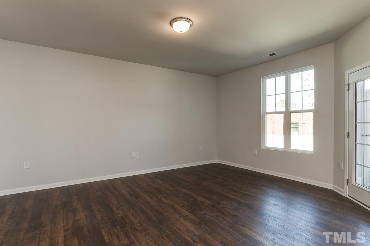 6055 Beale Loop, Unit 25 ABBEY Raleigh, NC 27616 - Photo 10 of 27 an empty room with wooden floor and windows