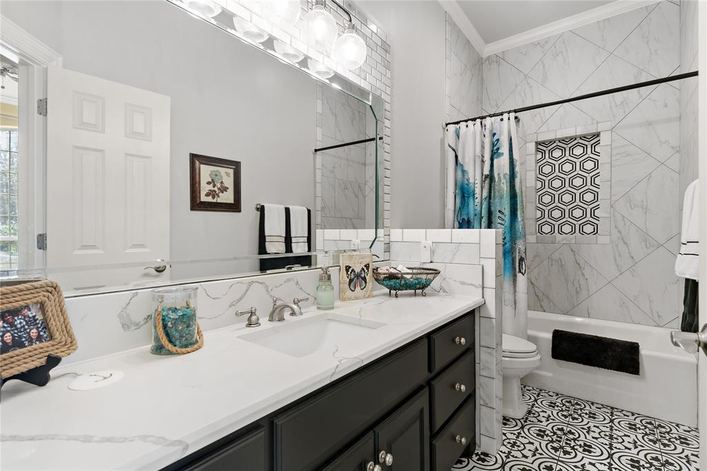 571 Hidden Lake Drive Powderly, TX 75473 - Photo 12 of 40 a bathroom with a sink double vanity and a shower