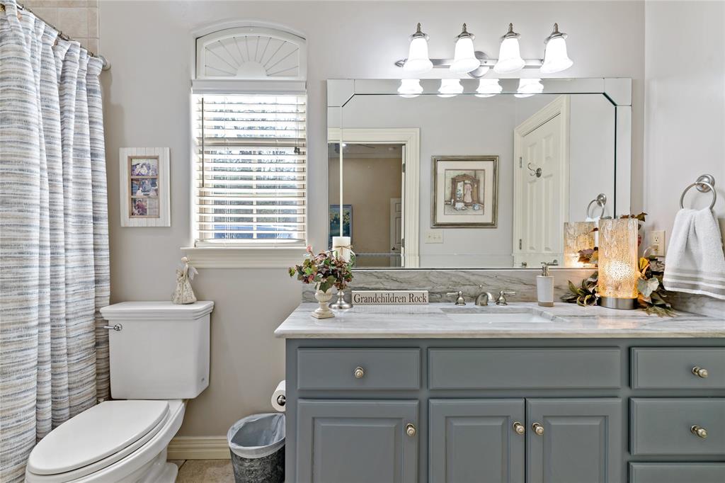 571 Hidden Lake Drive Powderly, TX 75473 - Photo 14 of 40 a bathroom with a sink vanity mirror and toilet