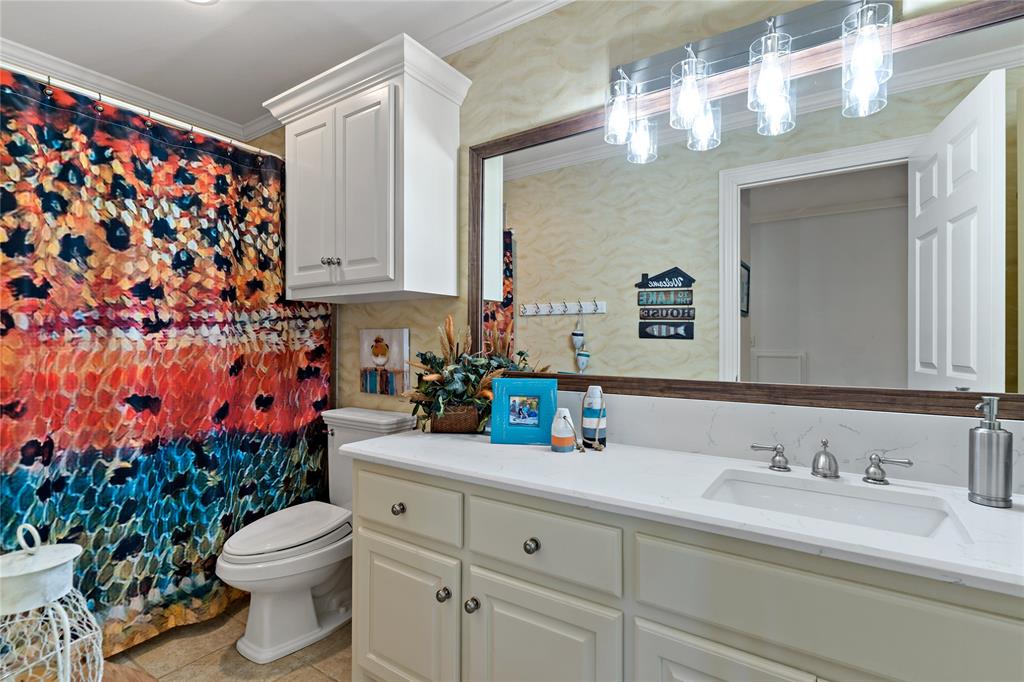 571 Hidden Lake Drive Powderly, TX 75473 - Photo 16 of 40 a bathroom with a granite countertop sink vanity mirror and toilet