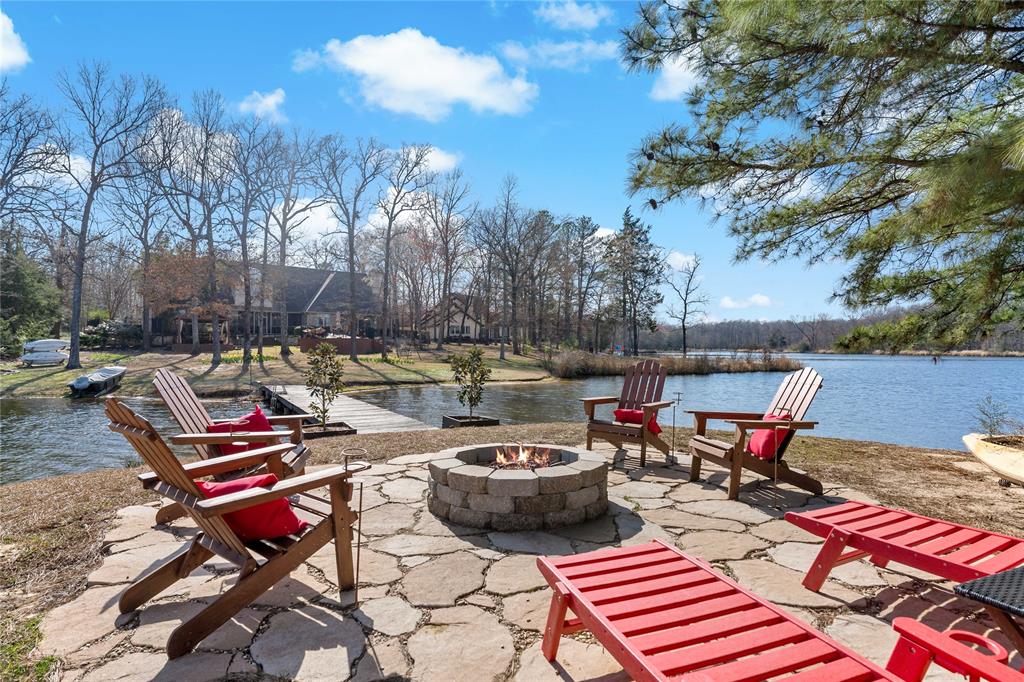 571 Hidden Lake Drive Powderly, TX 75473 - Photo 32 of 40 a view of a patio with table and chairs under an umbrella