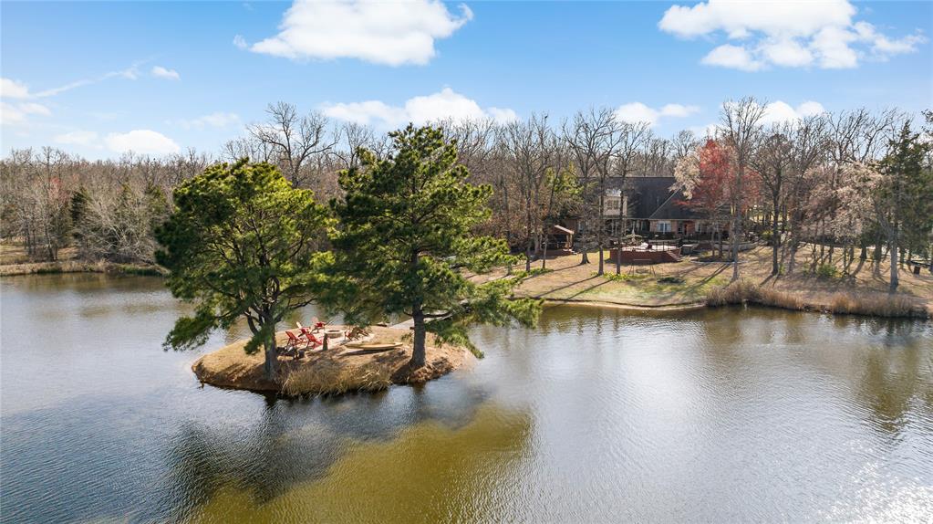 571 Hidden Lake Drive Powderly, TX 75473 - Photo 37 of 40 a view of a lake with boats and trees in the background