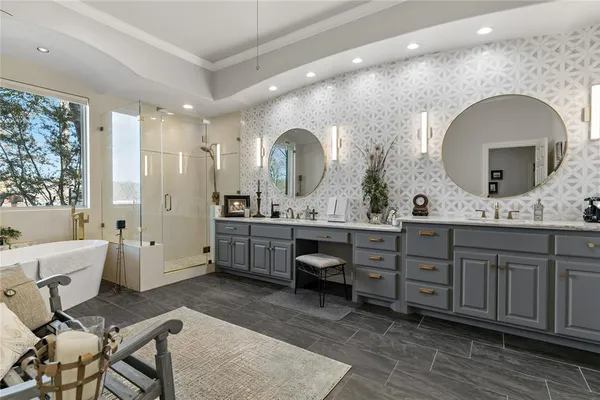 a spacious bathroom with a double vanity sink a mirror and a shower