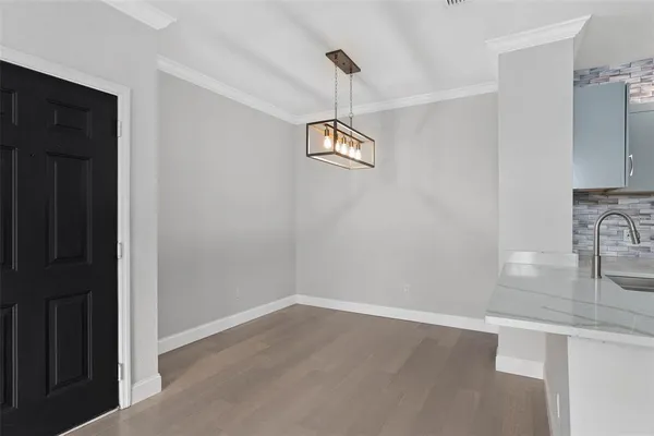 a view of a room with wooden floor and window