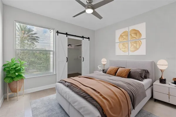 a bedroom with a large bed and a potted plant