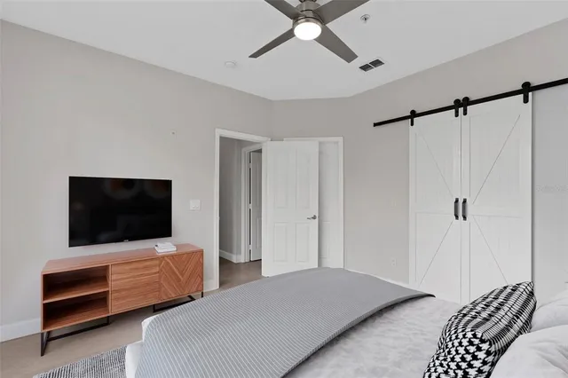 a bedroom with a bed and a flat screen tv