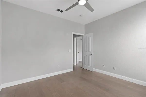 an empty room with a empty space and a ceiling fan