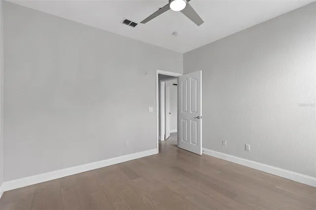 an empty room with a empty space and a ceiling fan