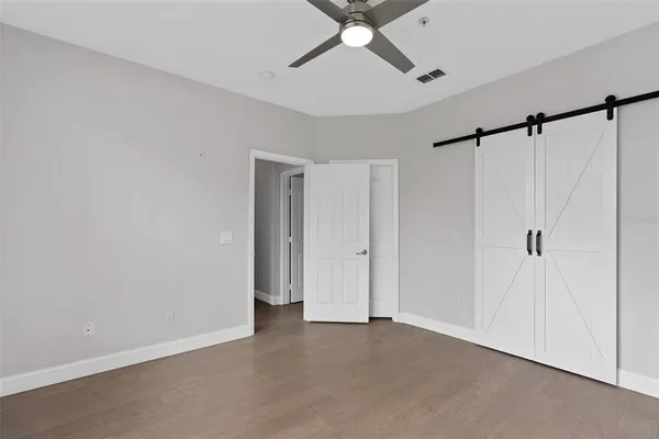 a view of a room with a ceiling fan