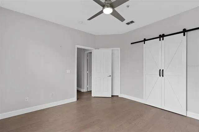 a view of a room with a ceiling fan