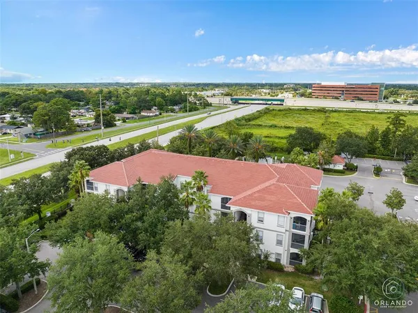 an aerial view of a house with a yard and lake view