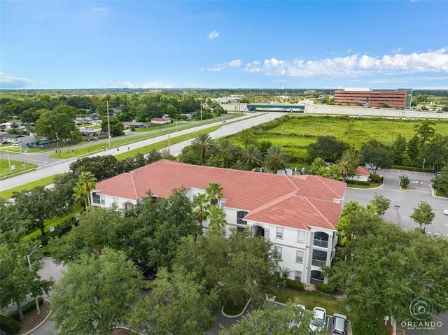 an aerial view of a house with a yard and lake view
