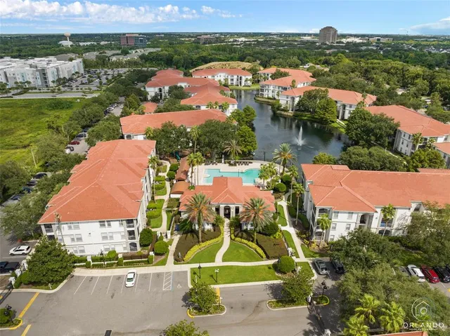 an aerial view of residential houses with outdoor space and river