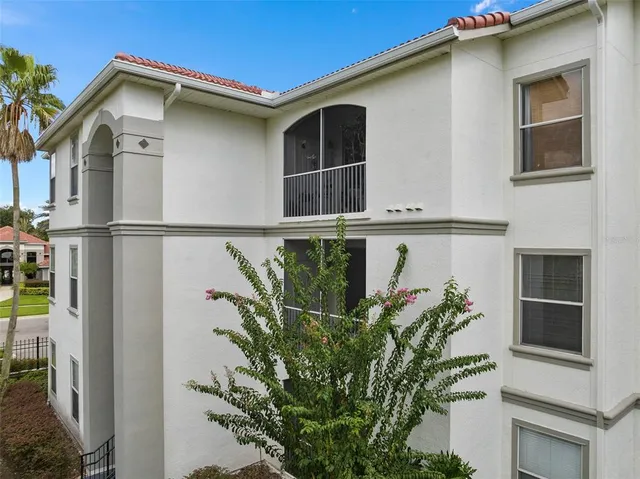 a view of a house with a window and potted plants