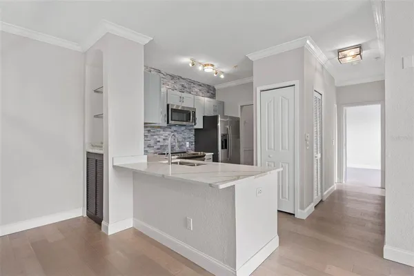a kitchen with kitchen island a sink appliances and cabinets