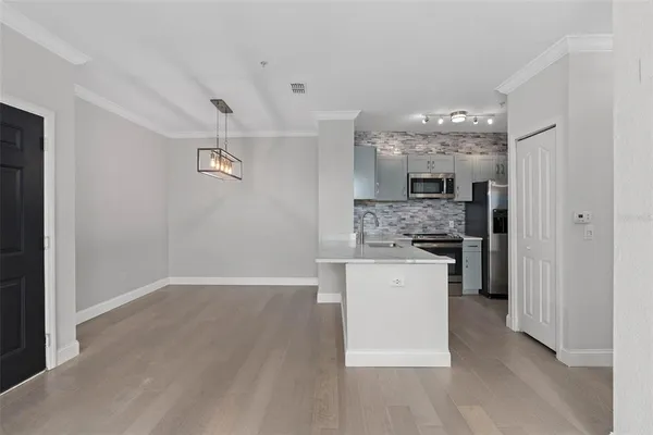 a kitchen with a refrigerator and a stove top oven