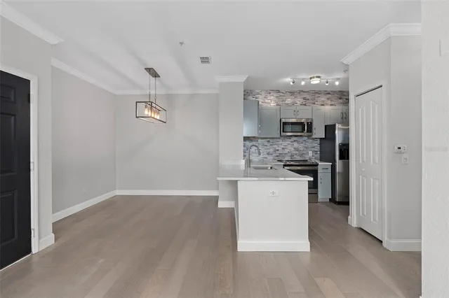 a kitchen with a refrigerator and a stove top oven
