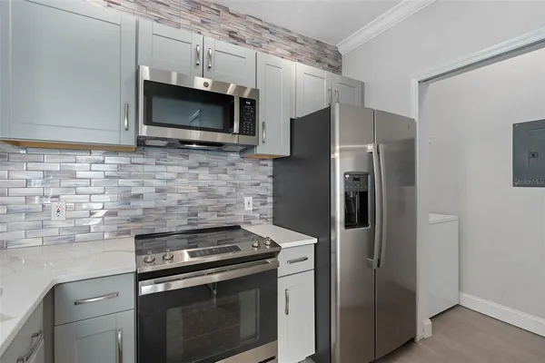 a kitchen with stainless steel appliances and cabinets