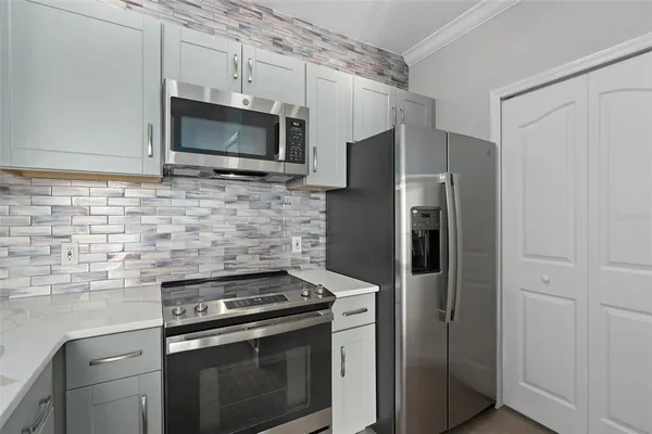 a kitchen with stainless steel appliances and cabinets