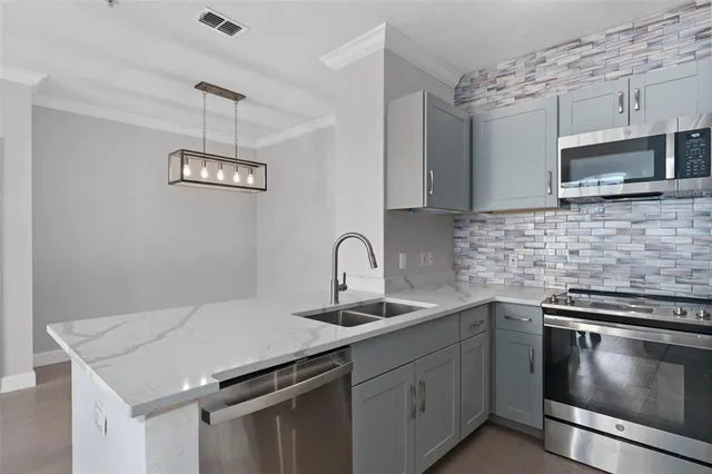 a kitchen with stainless steel appliances a microwave a stove and a microwave