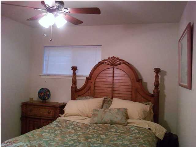 2634 Hwy Santa Rosa Beach, Unit 30A Santa Rosa Beach, FL 32459 - Photo 8 of 12 a bedroom with a bed and a chandelier